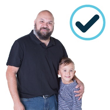 A man with his arm around a boy, they are both smiling and there is a tick above them. 