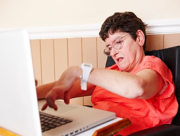 A woman with disability using a laptop.