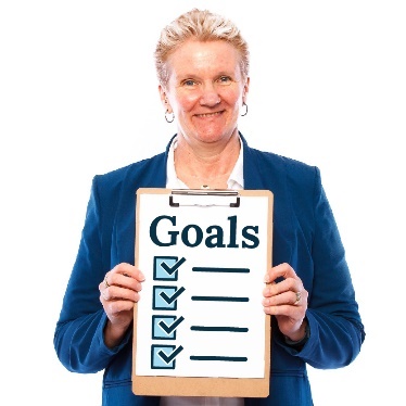 A person holding up a list of goals. 