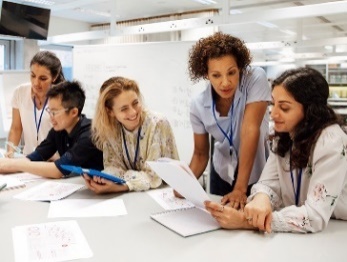 A photo of a group of people working on a research project together. 