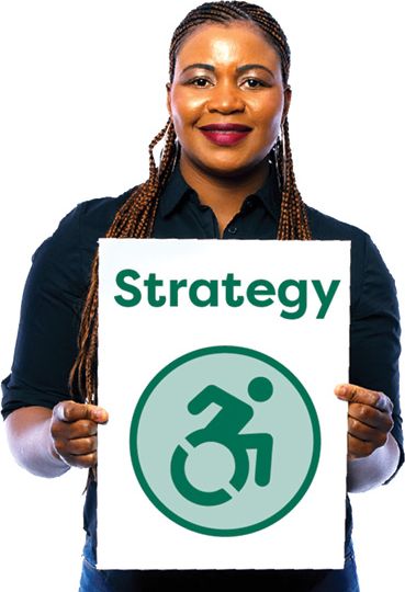 A person holding The Strategy document. The Strategy document is a document with a disability icon on it. The disability icon shows a person using a wheelchair.