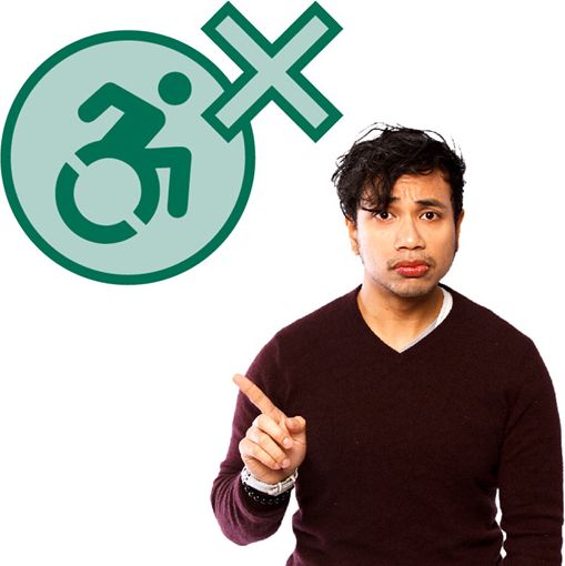 A person pointing to a disability icon with a cross.