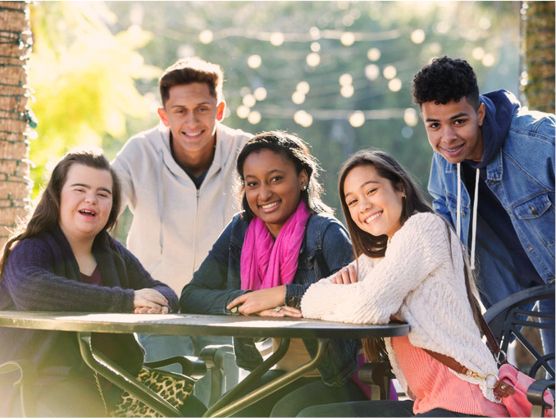 A diverse group of people from the community taking part in an activity in a park.