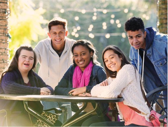 A diverse group of people from the community taking part in an activity in a park.