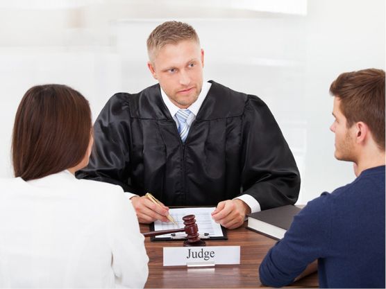 A judge listening to 2 people talk to them.