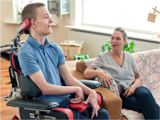 A carer supporting a person with disability in their home.