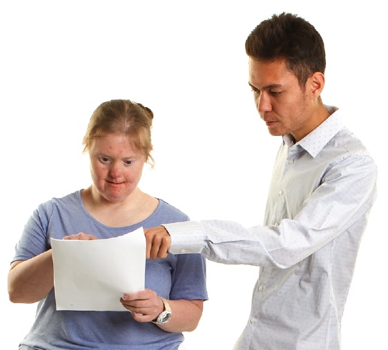 A support person helping someone read a document.