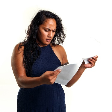 A person trying to read a document and looking confused.