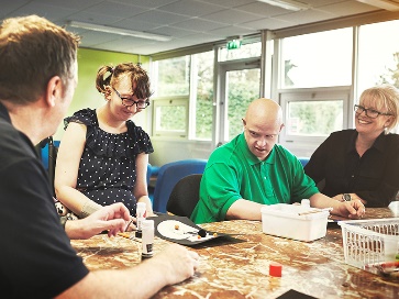 A group of people having a conversation at a table.