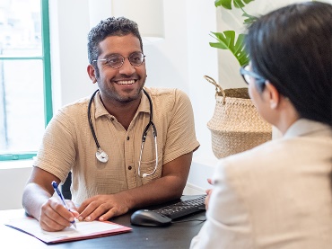 A doctor writing on a document. 