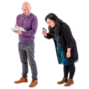 A person looking through a magnifying glass. A person writing on a clipboard.