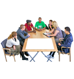 A group of people sitting at a table having a meeting.