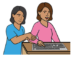 A person helping another person type on a keyboard.