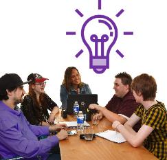 A group of people having a discussion around a table, above them is a lightbulb icon.