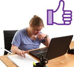 A person using a computer with a thumbs up next to them.