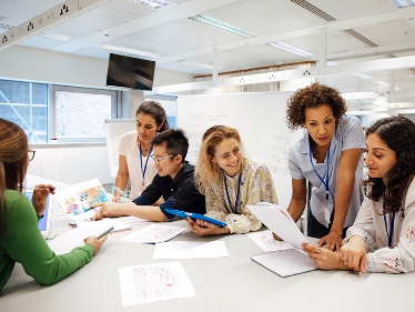 A group of researchers talking around a table.