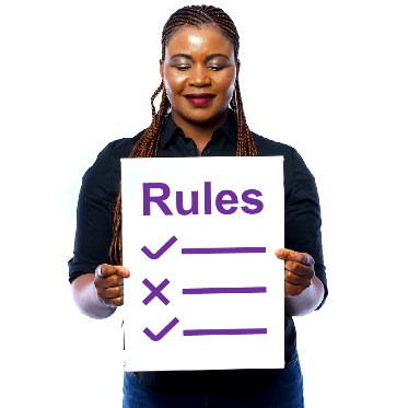 A person holding a document with 'Rules' written on it.