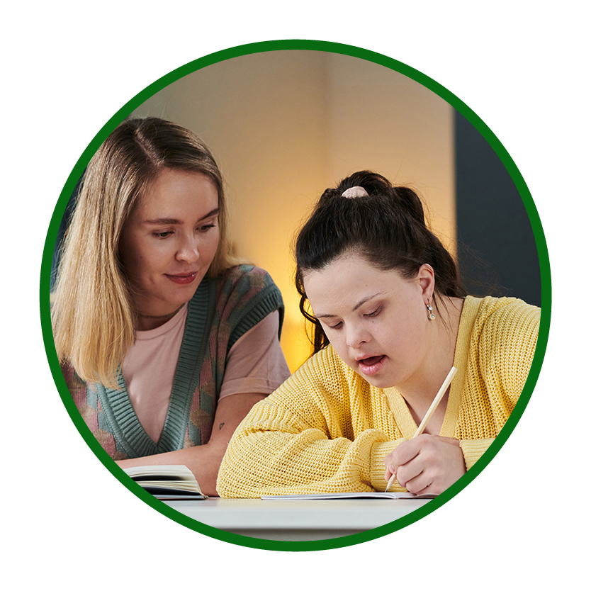 An adult supporting a young person to do their school work.