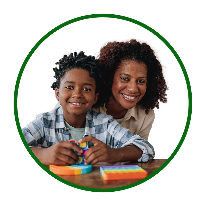 A child and their parent smiling.
