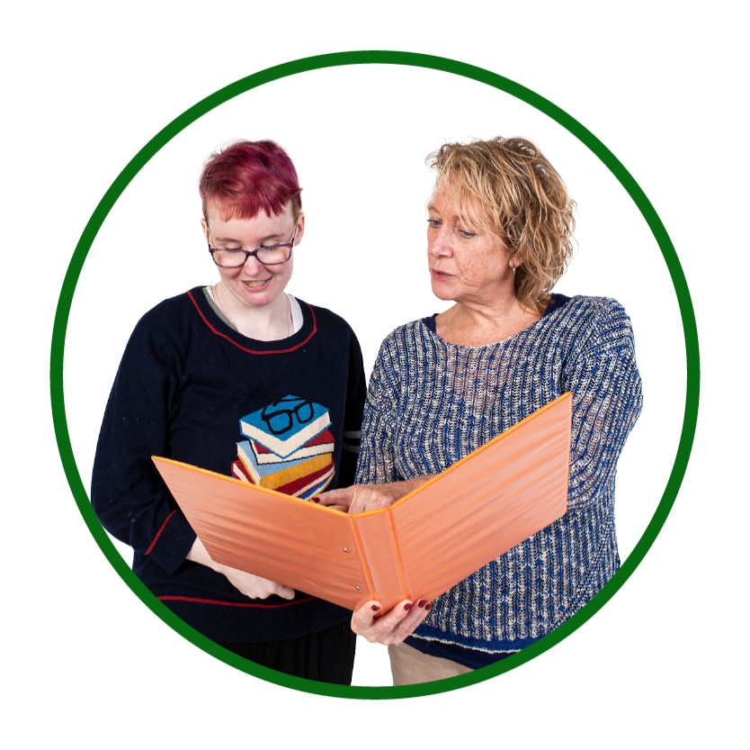 2 people reading a document together.