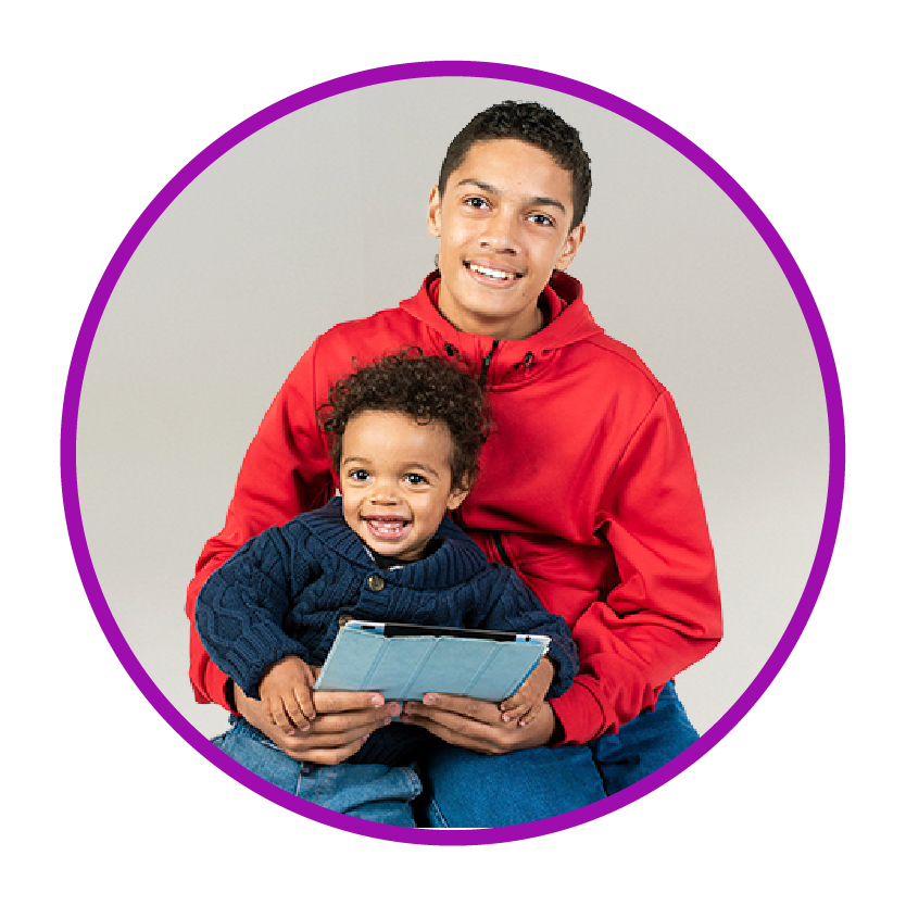 A child and a young person smiling.
