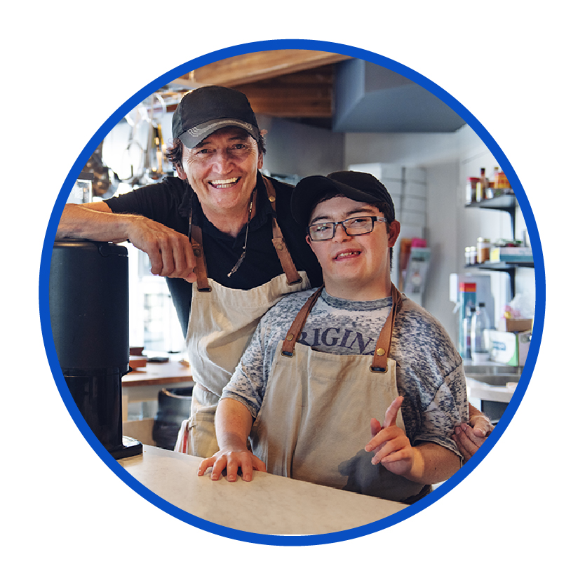 2 coworkers at a cafe smiling.