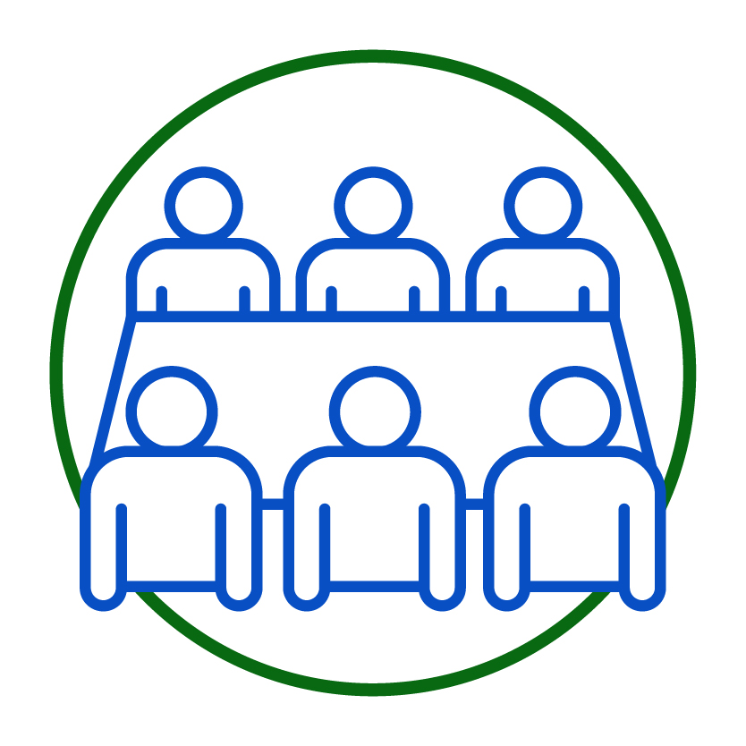 A group of people around a table having a meeting.