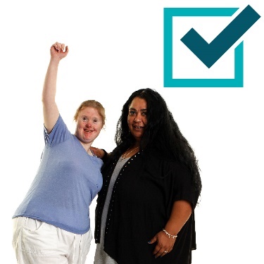 2 people and a box with a tick inside of it . 1 person is raising their fist in celebration. 