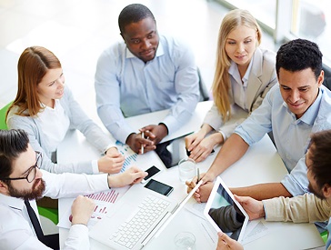 A group of people working together on a document .