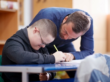 A person supporting another person to study.