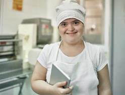 A person with disability working in a kitchen.