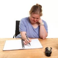 A person writing in a document.