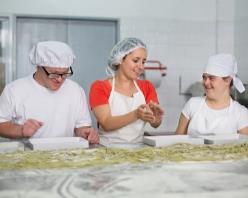 Three people working in a kitchen. 