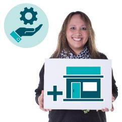 A person holding up an icon of a house with a plus sign on it. Above is a services icon.