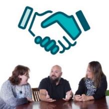 Three people talking together. Above is an agreement symbol.